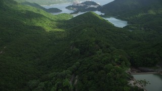 SS01_0062 - 5K stock footage aerial video fly over forest road through lush trees on Hong Kong Island, China