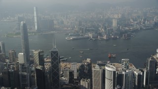 5K stock footage aerial video approach harbor from Hong Kong Island and pan across the water and Kowloon shoreline, China Aerial Stock Footage | SS01_0083