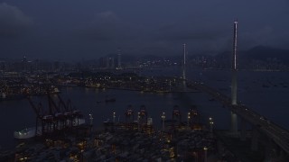 5K stock footage aerial video fly over containers at the Port of Hong Kong toward center of Stonecutters Bridge at night in China Aerial Stock Footage | SS01_0115