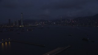 5K stock footage aerial video of approaching the Kowloon and Hong Kong Island skylines at night in China Aerial Stock Footage | SS01_0122