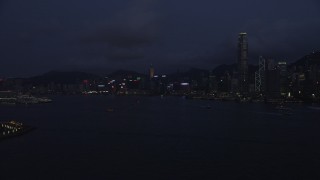 5K stock footage aerial video approach the Hong Kong Island skyline from Victoria Harbor at night, China Aerial Stock Footage | SS01_0128