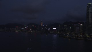 5K stock footage aerial video approach Hong Kong Island skyscrapers along the harbor at night, China Aerial Stock Footage | SS01_0130