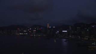 5K stock footage aerial video approach Hong Kong Island high-rises on the shore of the harbor at night, China Aerial Stock Footage | SS01_0131