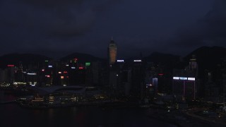 5K stock footage aerial video approach skyscrapers and convention center on Hong Kong Island at night, China Aerial Stock Footage | SS01_0133