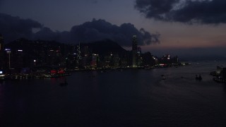 SS01_0141 - 5K stock footage aerial video skyline of Hong Kong Island, Victoria Harbor at nighttime in China