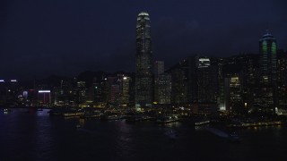 5K stock footage aerial video approach International Finance Centre and piers on Hong Kong Island at night, China Aerial Stock Footage | SS01_0147