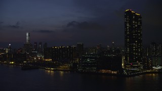 5K stock footage aerial video of Harbourfront Landmark skyscrapers and waterfront apartment buildings at night in Kowloon, Hong Kong, China Aerial Stock Footage | SS01_0158