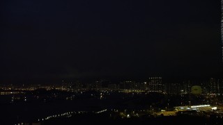 5K stock footage aerial video flash of lightning over distant Kowloon apartment buildings at night in Hong Kong, China Aerial Stock Footage | SS01_0164