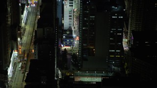 5K stock footage aerial video approach and tilt to a corner shop at night in Kowloon, Hong Kong, China Aerial Stock Footage | SS01_0206