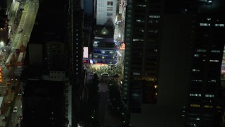 5K stock footage aerial video of pedestrians by a Kowloon shop at night in Hong Kong, China Aerial Stock Footage | SS01_0208