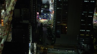 5K stock footage aerial video a slow reverse from corner shop at night in Kowloon, Hong Kong, China Aerial Stock Footage | SS01_0209