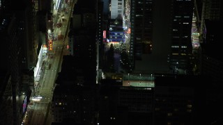 5K stock footage aerial video fly away from Kowloon shop and pedestrians at night in Hong Kong, China Aerial Stock Footage | SS01_0212