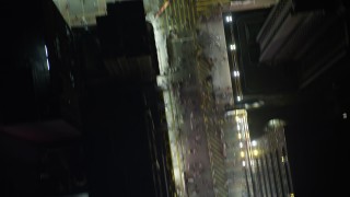 SS01_0213 - 5K stock footage aerial video a bird's eye view of pedestrians on city streets at night in Kowloon, Hong Kong, China