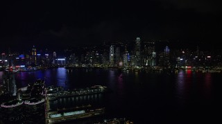 5K stock footage aerial video approach Hong Kong Island skyline from Kowloon piers at night, China Aerial Stock Footage | SS01_0215