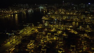 SS01_0235 - 5K stock footage aerial video fly over rows of shipping containers at night at the Port of Hong Kong, China