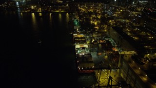 5K stock footage aerial video fly over a row of cargo ships docked at the Port of Hong Kong at nighttime, China Aerial Stock Footage | SS01_0237