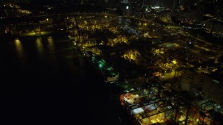 5K stock footage aerial video flyby a pair of cargo ships docked at the Port of Hong Kong at night, China Aerial Stock Footage | SS01_0238