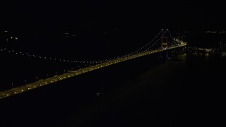 5K stock footage aerial video approach the center of the Tsing Ma Bridge at night in Hong Kong, China Aerial Stock Footage | SS01_0242