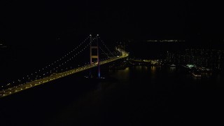 5K stock footage aerial video of passing part of the Tsing Ma Bridge at night in Hong Kong, China Aerial Stock Footage | SS01_0244