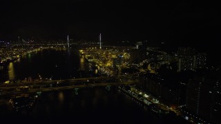 SS01_0260 - 5K stock footage aerial video fly over Rambler Channel at night to approach Stonecutters Bridge and Port of Hong Kong, China