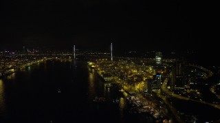 SS01_0261 - 5K stock footage aerial video follow Rambler Channel by the Port to Hong Kong at night to approach Stonecutters Bridge, China