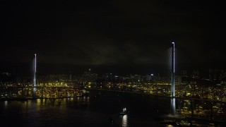 5K stock footage aerial video of Stonecutters Bridge at Night in Hong Kong with lightning flashes overhead, China Aerial Stock Footage | SS01_0269