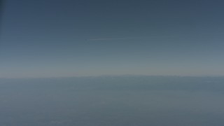 WA001_028 - 4K stock footage aerial video air-to-air of a jet airplane contrail over mountains in Solano County, California