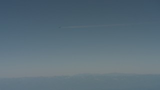 4K stock footage aerial video air-to-air view of a jet airplane contrail flying over mountains in Solano County, California Aerial Stock Footage | WA001_029