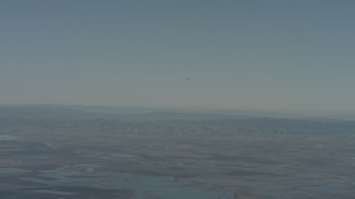 4K stock footage aerial video air-to-air of a jet flying over mountains in the distance, Solano County, California Aerial Stock Footage | WA001_046