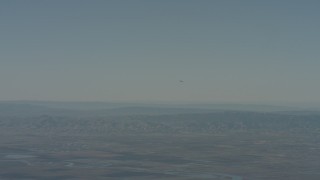 4K stock footage aerial video air-to-air view of a jet over mountains in Solano County, California Aerial Stock Footage | WA001_047