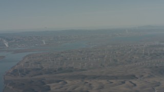 WA001_049 - 4K stock footage aerial video air-to-air of a jet flying near windmills and the Sacramento River in Solano County, California