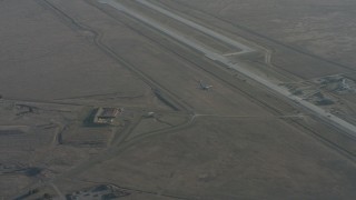 WA001_055 - 4K stock footage aerial video zoom to a wider view of a Boeing C-17 flying by Travis Air Force Base, California