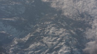 4K stock footage aerial video of snowy mountains by the edge of cloud cover in the Sierra Nevada Mountains, California Aerial Stock Footage | WA002_047