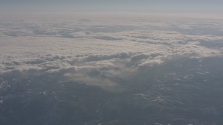 4K stock footage aerial video of clouds rolling over snowy mountains in the Sierra Nevada Mountains, California Aerial Stock Footage | WA002_048