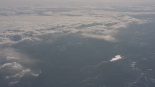 4K stock footage aerial video of snowy mountains and a pair of lakes near dense cloud layer in the Sierra Nevada Mountains, California Aerial Stock Footage | WA002_050