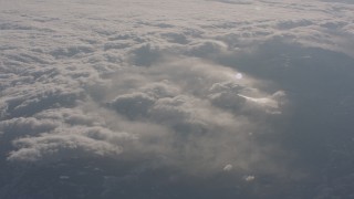 4K stock footage aerial video of misty clouds above snowy Sierra Nevada Mountains, California Aerial Stock Footage | WA002_052