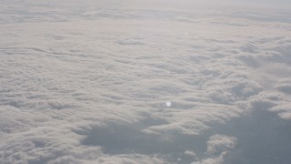 WA002_053 - 4K stock footage aerial video tilt from snowy mountains to reveal a cover of clouds in Sierra Nevada Mountains, California