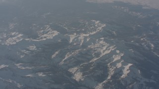 4K stock footage aerial video fly away from snow-covered ridges in the Sierra Nevada Mountains, California Aerial Stock Footage | WA002_056