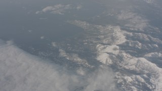 4K stock footage aerial video pan across clouds and Lake Tahoe to reveal snowy mountains, California Aerial Stock Footage | WA002_072