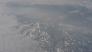 4K stock footage aerial video of snowy Sierra Nevada Mountains and misty clouds in California Aerial Stock Footage | WA002_076