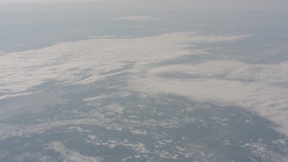 4K stock footage aerial video of a reverse view of clouds over snowy mountains in Modoc County, California Aerial Stock Footage | WA004_015