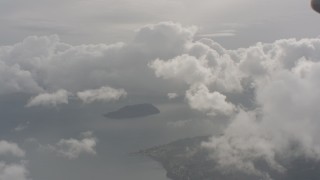 WA004_038 - 4K stock footage aerial video flyby white clouds over a small island in Puget Sound in Washington