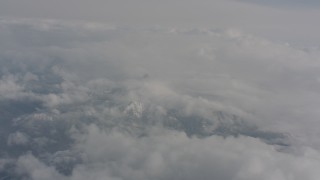 4K stock footage aerial video fly over clouds over snowy mountains in Washington Aerial Stock Footage | WA004_064