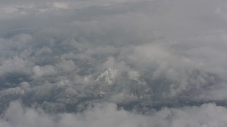 4K stock footage aerial video of snow-capped mountains beneath the clouds over Washington Aerial Stock Footage | WA004_066