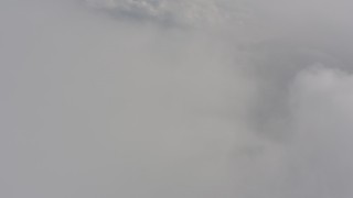 4K stock footage aerial video fly over misty clouds toward denser cloud cover over Washington Aerial Stock Footage | WA004_071