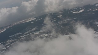 4K stock footage aerial video fly over clouds to approach snowy forests in Washington Aerial Stock Footage | WA004_088