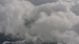 4K stock footage aerial video tilt from bird's eye of forest and snow to reveal clouds in Washington Aerial Stock Footage | WA004_089