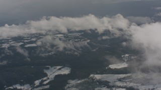 4K stock footage aerial video fly over misty clouds to reveal evergreens and snow below in Washington Aerial Stock Footage | WA004_091