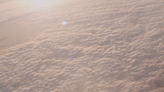 WA005_009 - 4K stock footage aerial video pan across a layer of clouds around the Port of Los Angeles at sunset, California