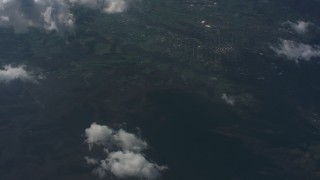 WA005_095 - 4K stock footage aerial video tilt from clouds over West Virginia to a bird's eye view of mountains, lake and countryside